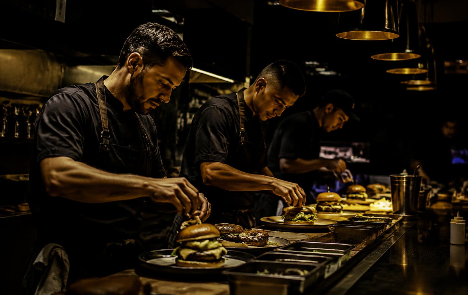 Chefs plating burgers in the studio